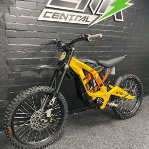 the crowd with the yellow limited edition surron light bee for sale, a stunning electric dirt bike that combines eye-catching color